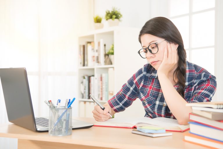 bored young woman with laptop computer